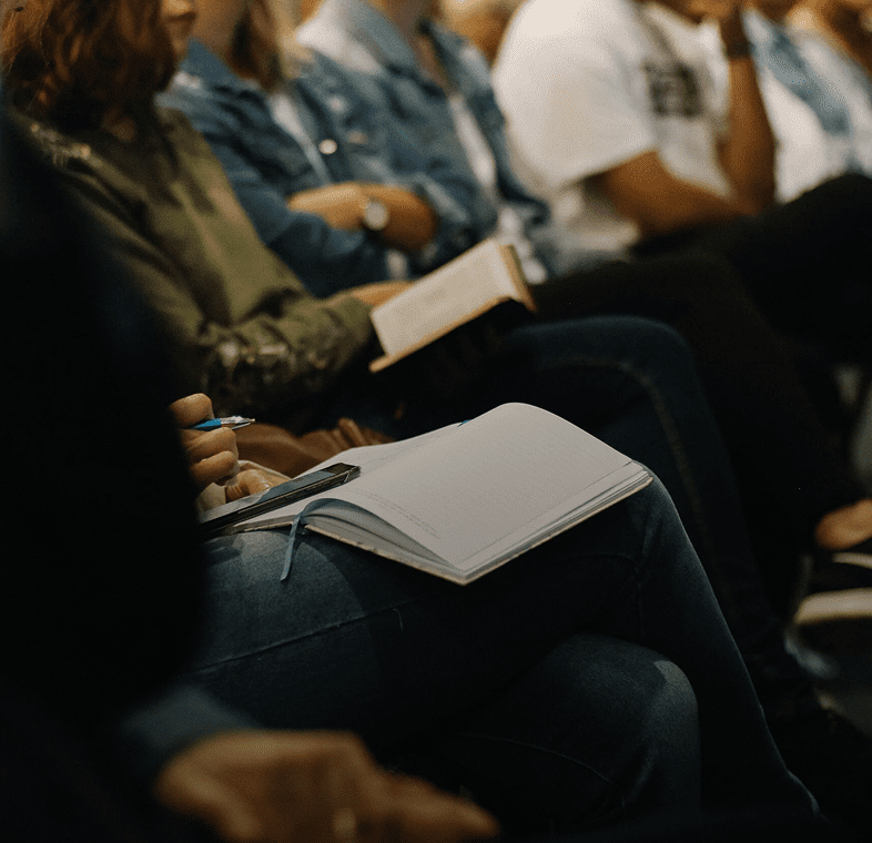 Audience taking notes during a seminar