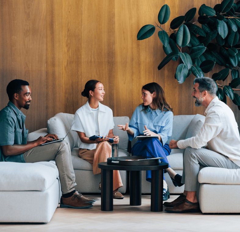 Group meeting on modern couches indoors.